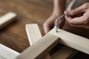woman-screwing-chair-rsquo-s-nail-ready-assemble-furniture